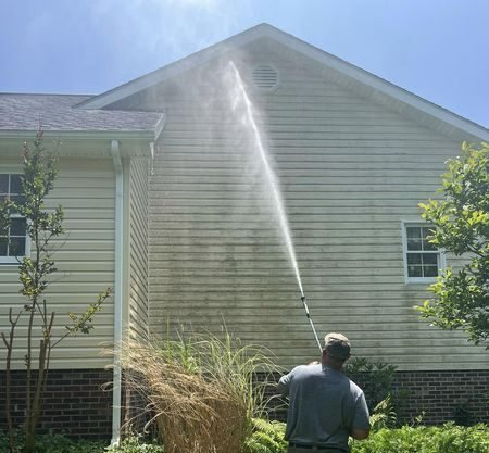 A long range water arc reaching the full height of a tall house from the ground