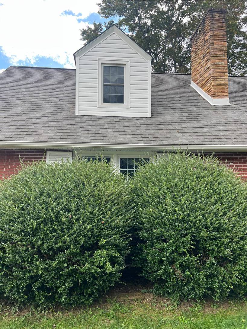 The same cape cod roof with the streaking gone and the shingles back to an even grey