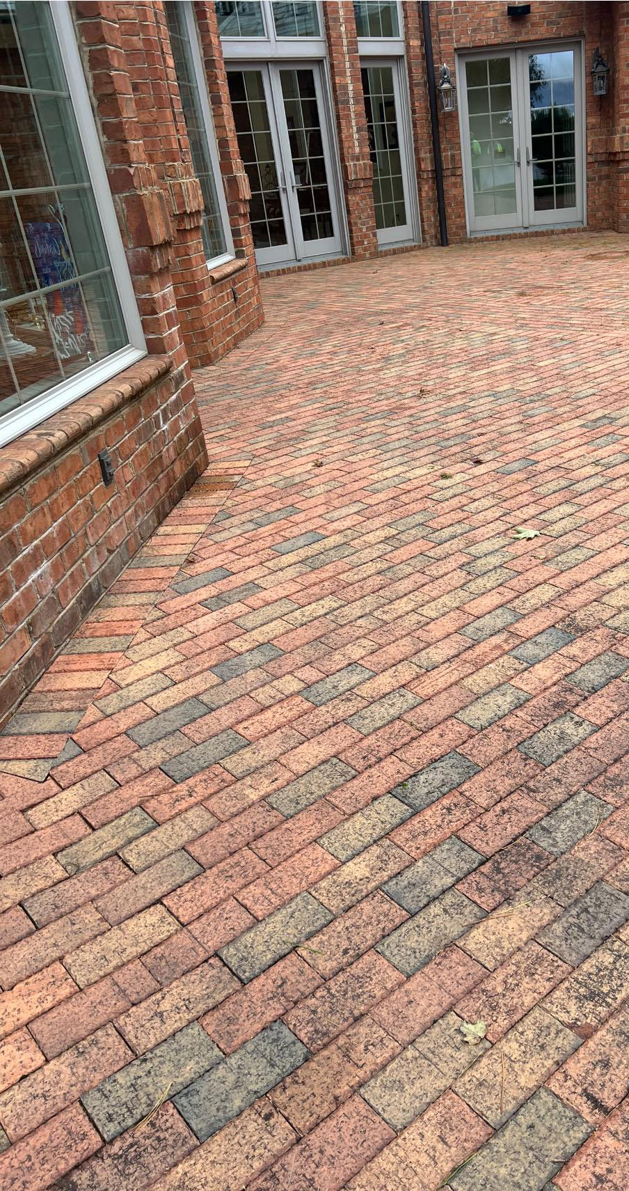 Brick before cleaning with dark spots, dirt, and grime.